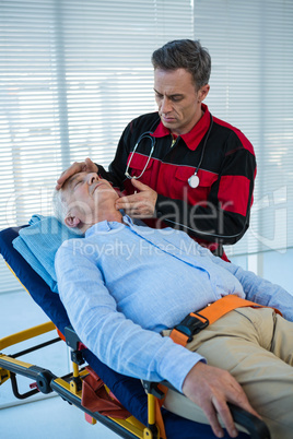 Paramedic examining the patient