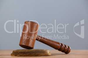 Wooden gavel placed on wooden table