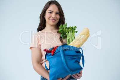 Beautiful woman carrying grocery bag