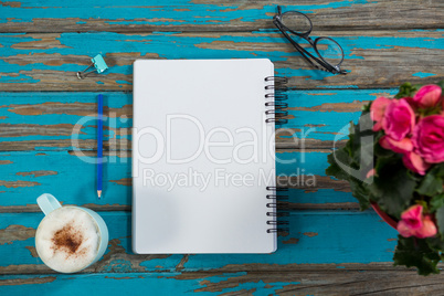 Coffee with notepad and flower vase