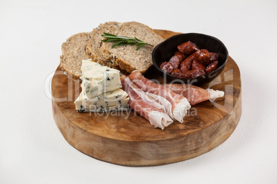 Bread slice, cheese and meat on wooden board