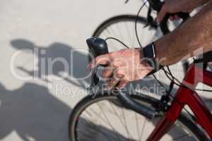 Close-up of mans hand wearing smartwatch while riding bicycle