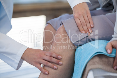 Doctor examining patient knee