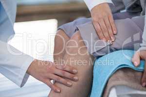 Doctor examining patient knee