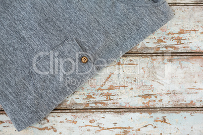 Grey t-shirt on wooden table