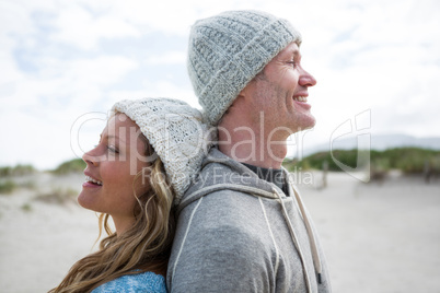 Mature couple standing back to back