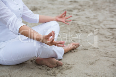Mid section of woman performing yoga