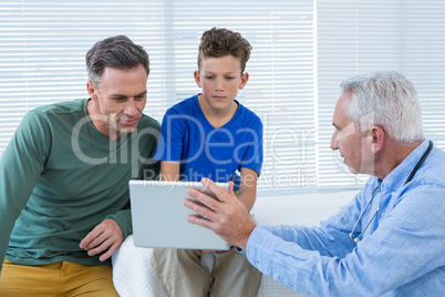 Doctor and patient discussing over digital tablet