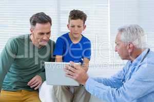 Doctor and patient discussing over digital tablet
