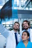 Doctors and nurse examining X-ray report