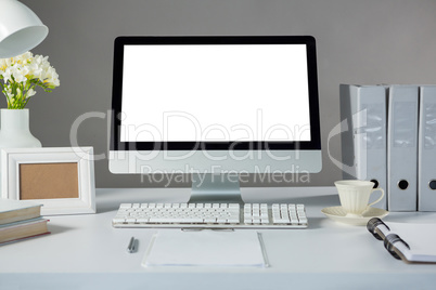 Desktop pc with picture frame and cup of coffee