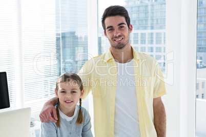 Portrait of girl sitting on the examination table with her father