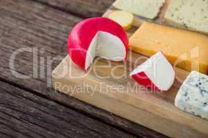 Variety of cheese on wooden board