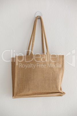Beige fabric bag hanging on wall