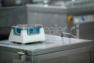 Weighing scale on worktop at meat factory