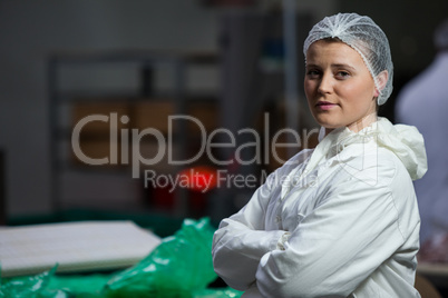 Female butcher standing with arms crossed