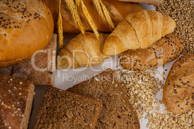 Various bread loaves with wheat grains