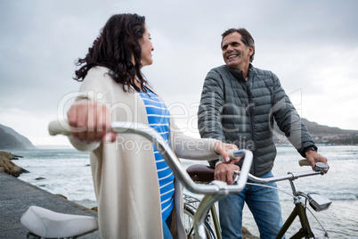 Happy couple on bicycle interacting with each other