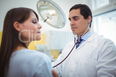 Doctor examining a female patient