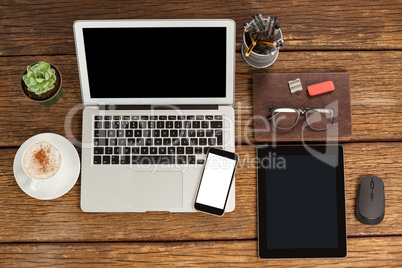 Laptop, smartphone and digital tablet with cup of coffee