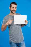 Handsome man holding a blank placard