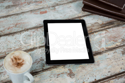 Digital tablet with cup of coffee