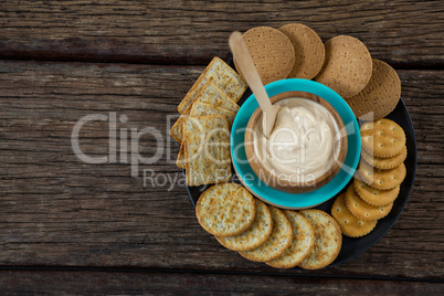 Cheese sauce with biscuits in black plate