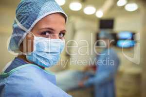 Portrait of female surgeon wearing surgical mask in operation theater