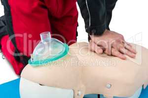 Paramedic practising resuscitation on dummy