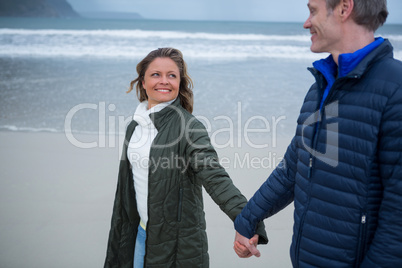 Romantic couple holding hands on beach