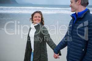 Romantic couple holding hands on beach