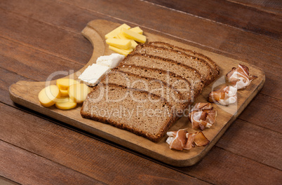 Slices of brown bread and variety of cheese