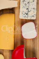 Various cheese on wooden board