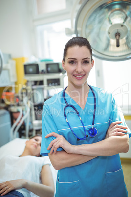 Portrait of nurse standing in medical examination room