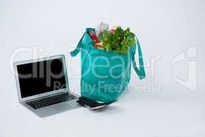 Grocery bag with wallet and laptop