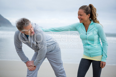 Couple exercising on beach