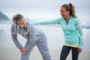 Couple exercising on beach