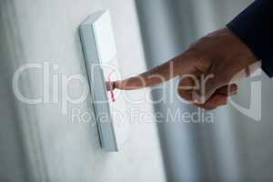 Hand of a businessman pressing the button in an elevator