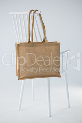 Jute bag hanging on a white chair