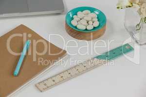 Ruler, pen, pebbles, and diary