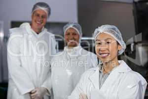 Team of butcher standing in meat factory