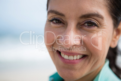 Close-up of smiling woman on beach