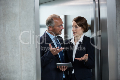 Businessman with colleague in an elevator