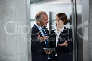 Businessman with colleague in an elevator