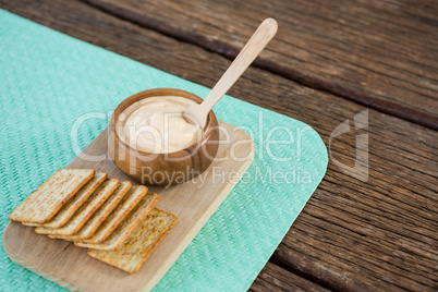 Cheese sauce with bread on serving board