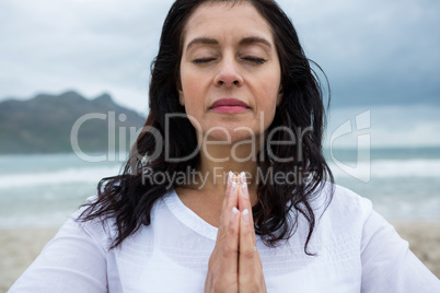 Woman performing yoga on beach