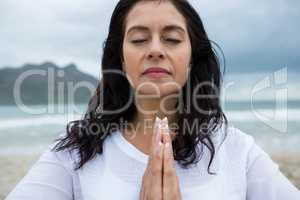 Woman performing yoga on beach