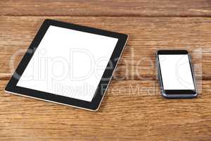 Digital tablet and smartphone on wooden plank