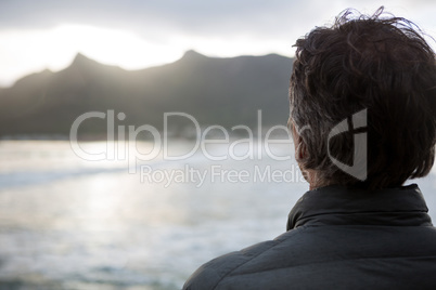 Rear view of man standing on beach