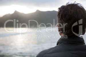 Rear view of man standing on beach